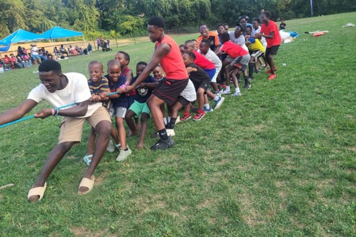 The youth taking part in the tug of war (rope pulling game)